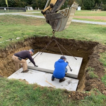 Setting two 4000-lb concrete anchoring pads
