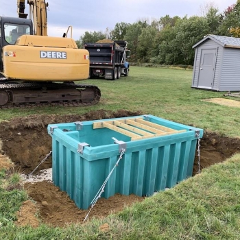 Composter anchored to concrete